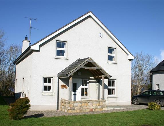 Large white two store house with stone porch feature