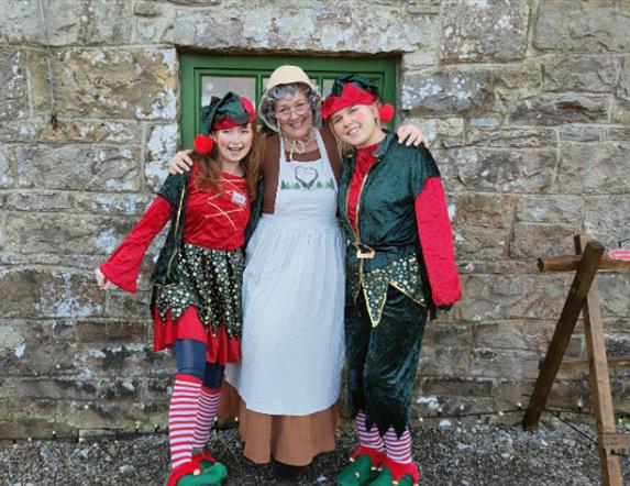 Mrs Claus welcomes families into her cosy Christmas cottage, surrounded by twinkling lights and festive decorations. Children listen to her heartwarmi