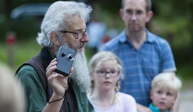 A National Trust ranger holding a bat detector