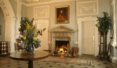 The Entrance Hall at Florence Court, Co Fermanagh, Northern Ireland, showing the doric stone chimney piece with triglyphs and pediment and the rustica