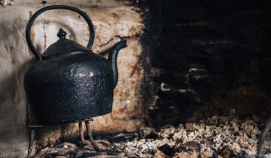 Image of kettle on the hearth at the Ulster American Folk Park