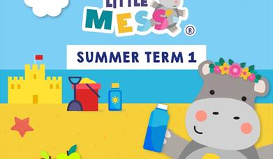 Picture shows Hetty Hippo having fun with messy play on the beach in the sunshine!