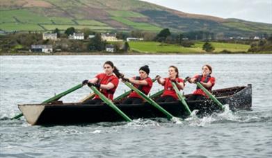 4 women rowing