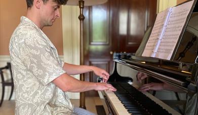 Jonathan Beatty playing the grand piano at Castle Coole