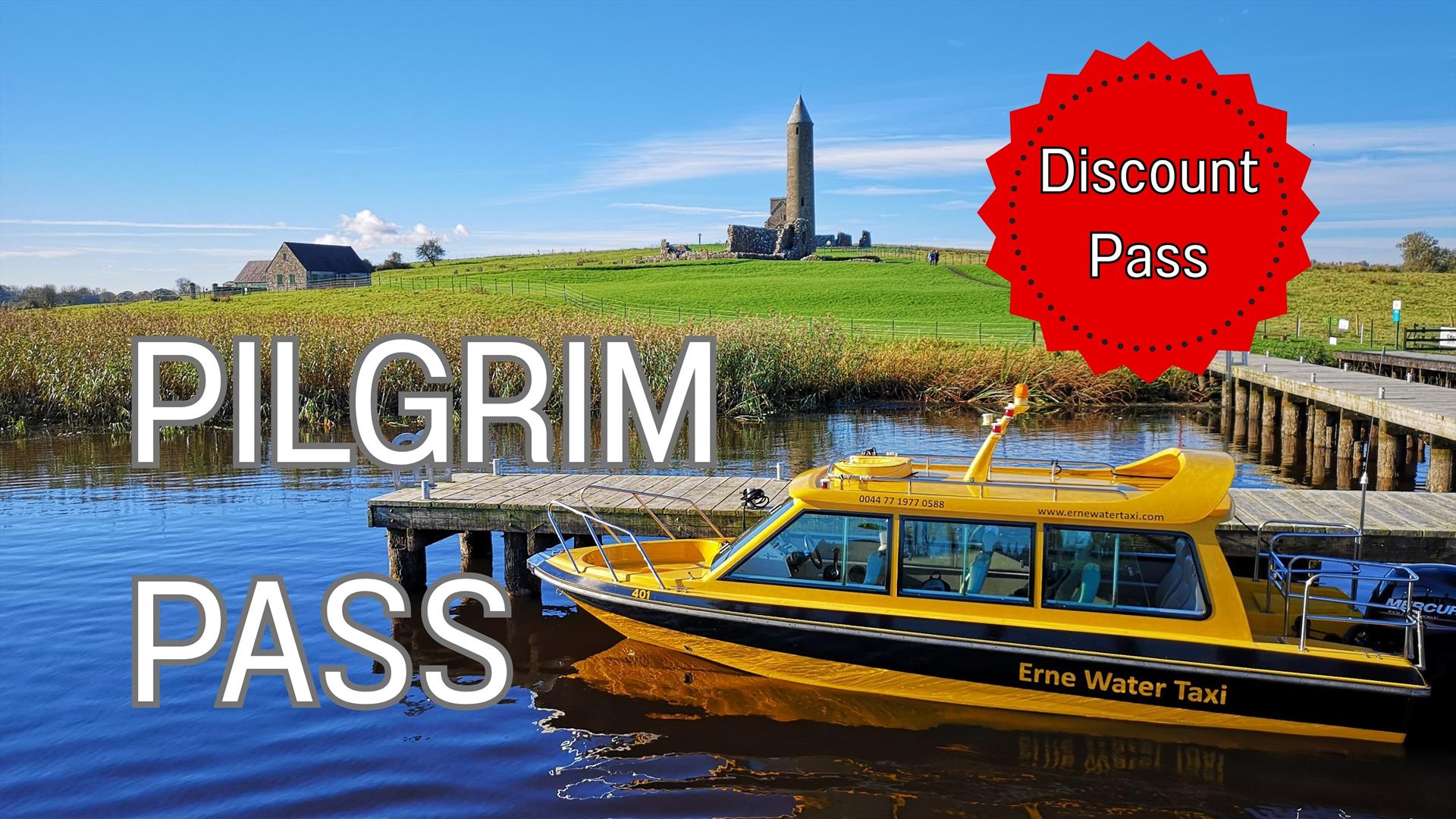 Yellow boat moored at jetty with Devenish Round Tower in the background