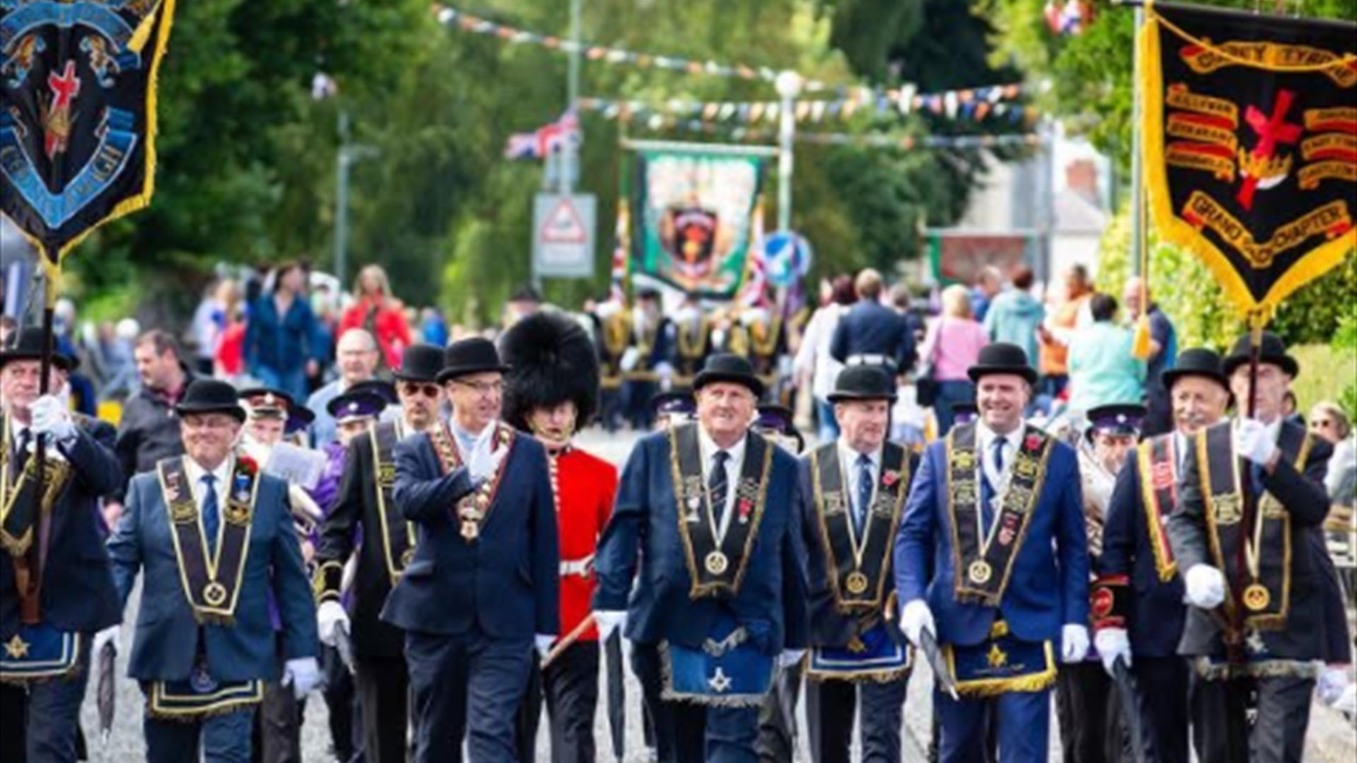 Men with Black sashes parading