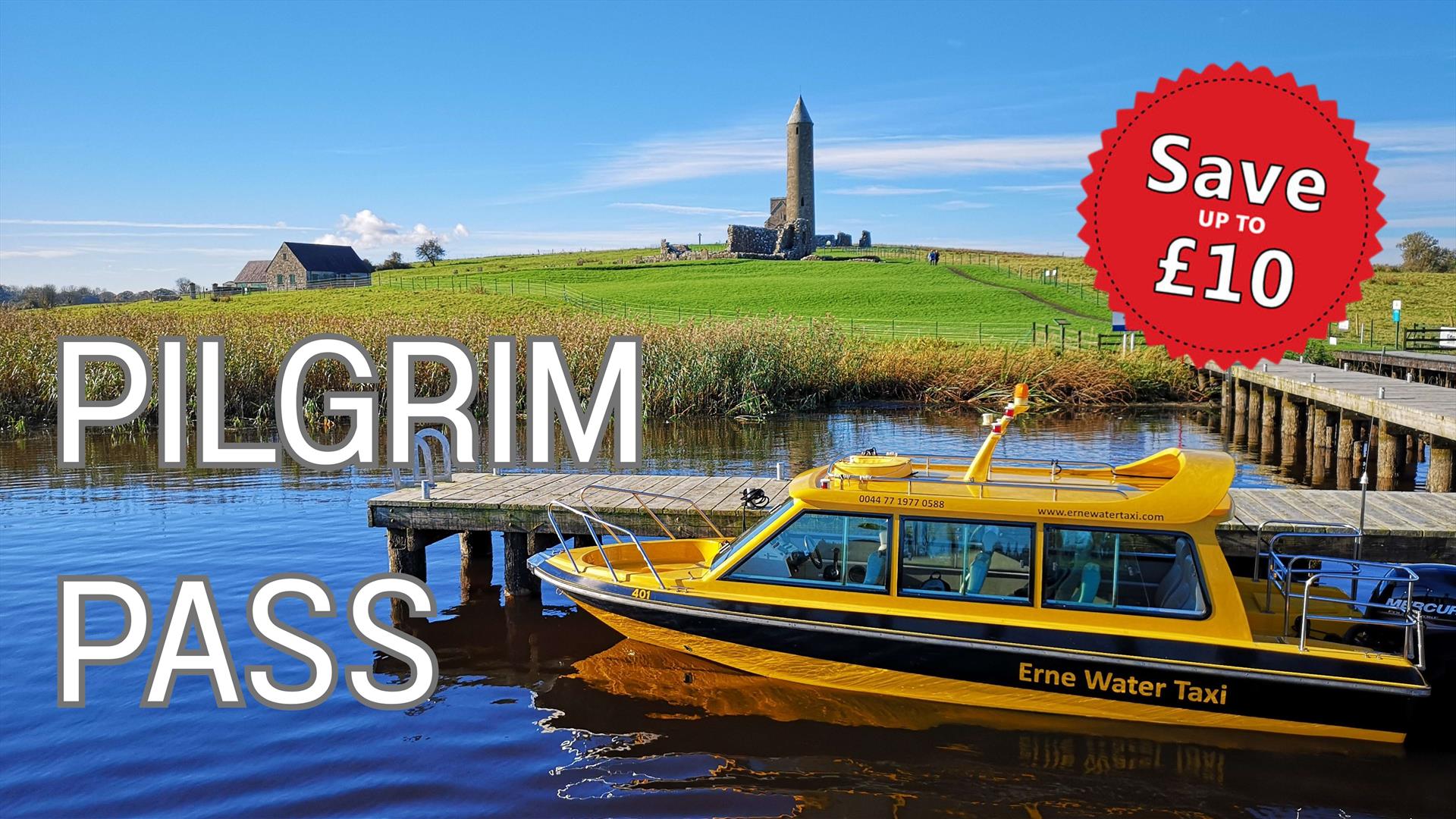 Yellow Water Taxi moored at the jetty with Devenish Tower in the background