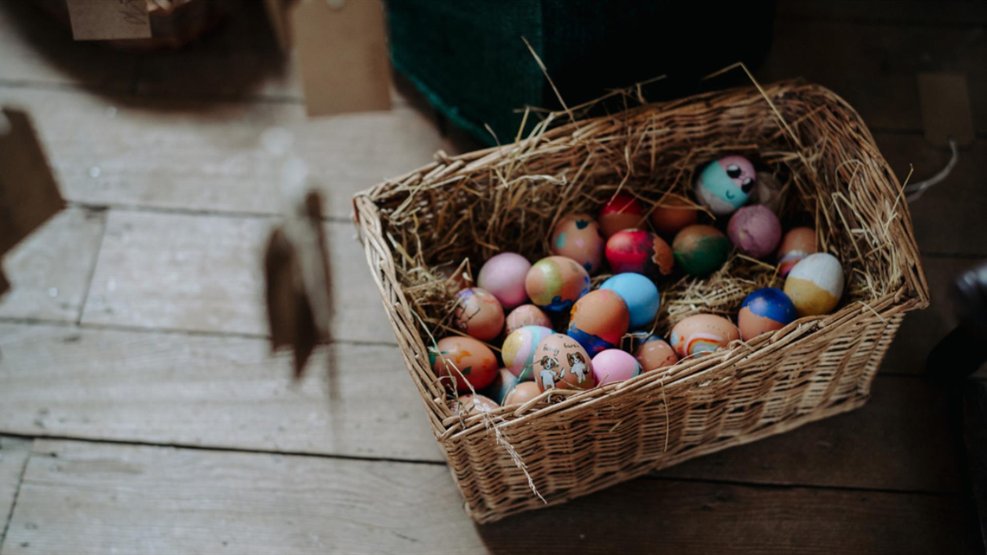 Painted egg shells in a wicker basket