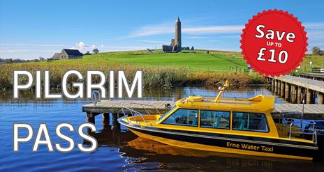 Yellow Water Taxi moored at the jetty with Devenish Tower in the background