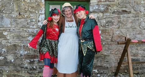 Mrs Claus welcomes families into her cosy Christmas cottage, surrounded by twinkling lights and festive decorations. Children listen to her heartwarmi