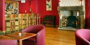 lounge area with bar, wood burning stove and tables and chairs