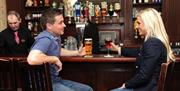 Image of a couple enjoying a beverage at the bar