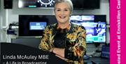 Linda McCauley smiling in a BBC Radio studio