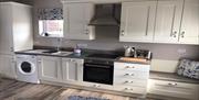 Kitchen at Cosy Nook Cottage.  Complete with Fridge-freezer, Microwave, Washing Machine, Dishwasher, Hob and Oven.
