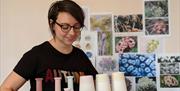Meet the Maker  Rachel Leary carrying tray of ceramic pots and mugs.