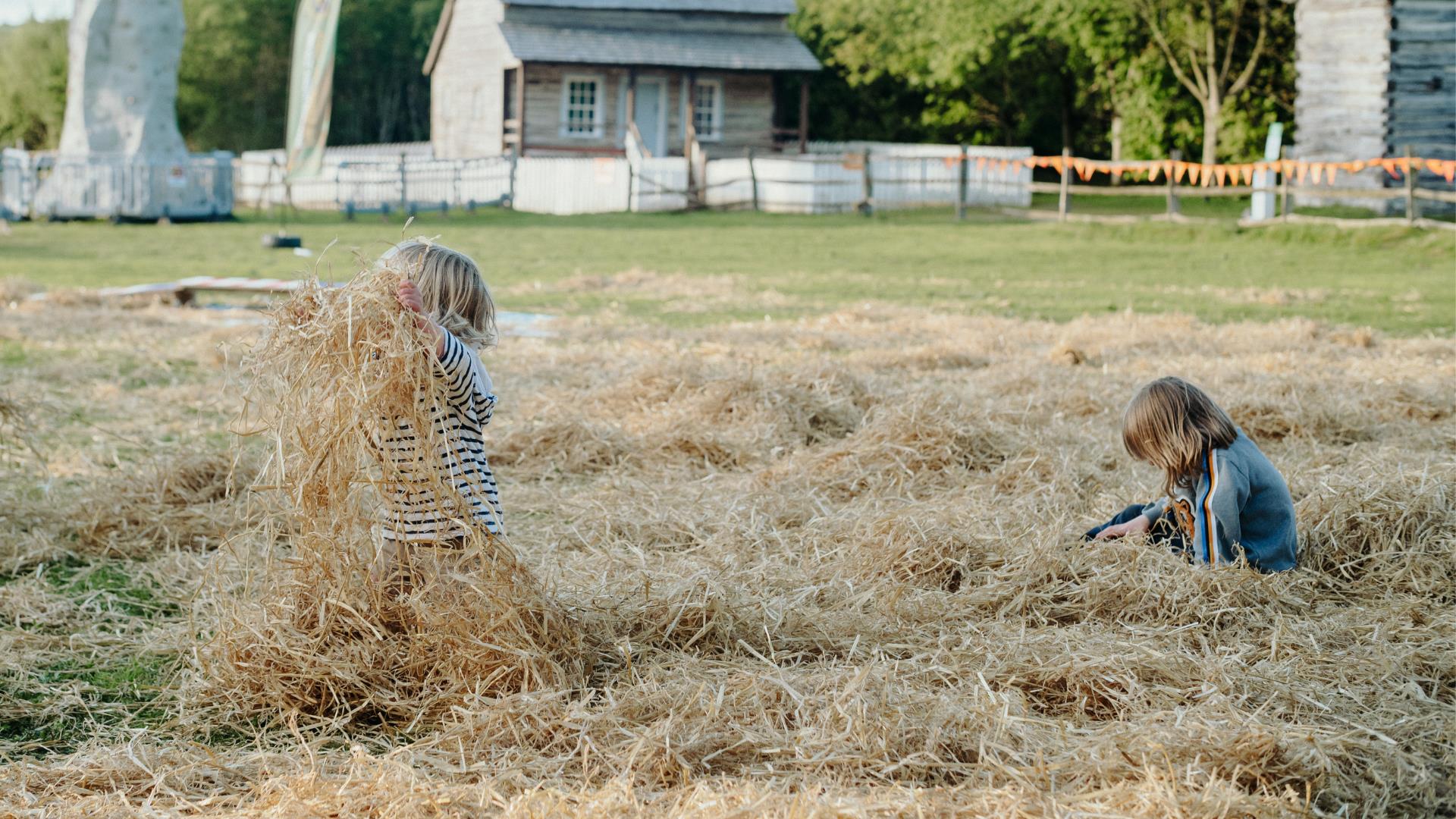 two children in a hay bale