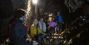 group follows their leader on a guided tour of the marble arch caves